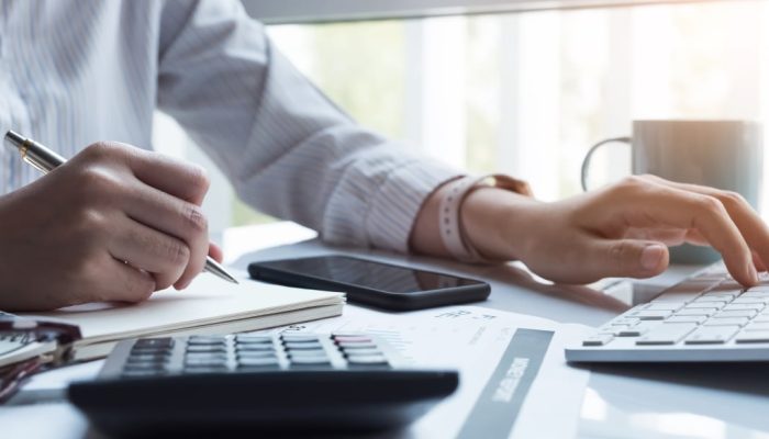 mão de mulher empreendedora fazendo cálculos para sua empresa individual